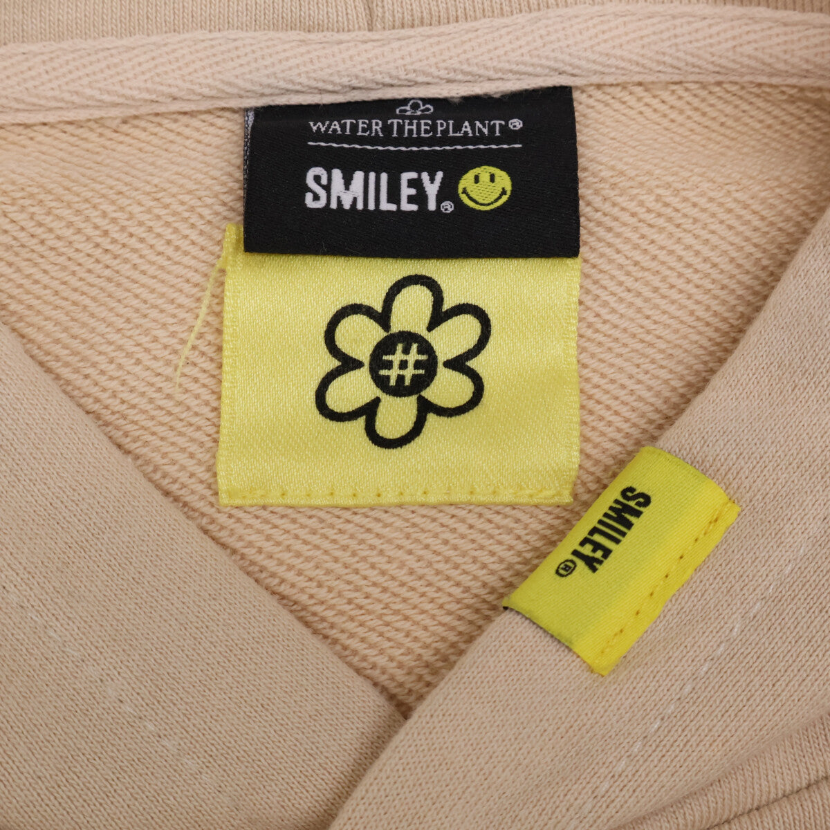 WATER THE PLANT ウォーターザプラント ﾍﾞｰｼﾞｭ ｺｯﾄﾝ ｽﾏｲﾘｰﾛｺﾞ ﾊﾞｯｸﾌﾟﾘﾝﾄ ｽｳｪｯﾄﾌｰﾃﾞｨﾌﾟﾙｵｰﾊﾞｰ トップス M